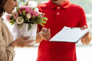 man delivering bouquet of flowers to mom