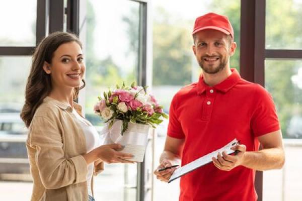 A man delivers flowers to a woman