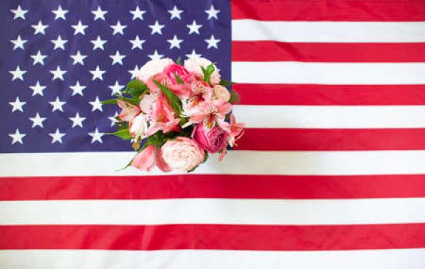 A floral arrangement sits on an American flag